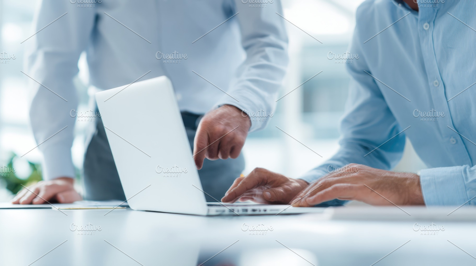 Team members discuss work on laptop, a Photo by Beautiful things