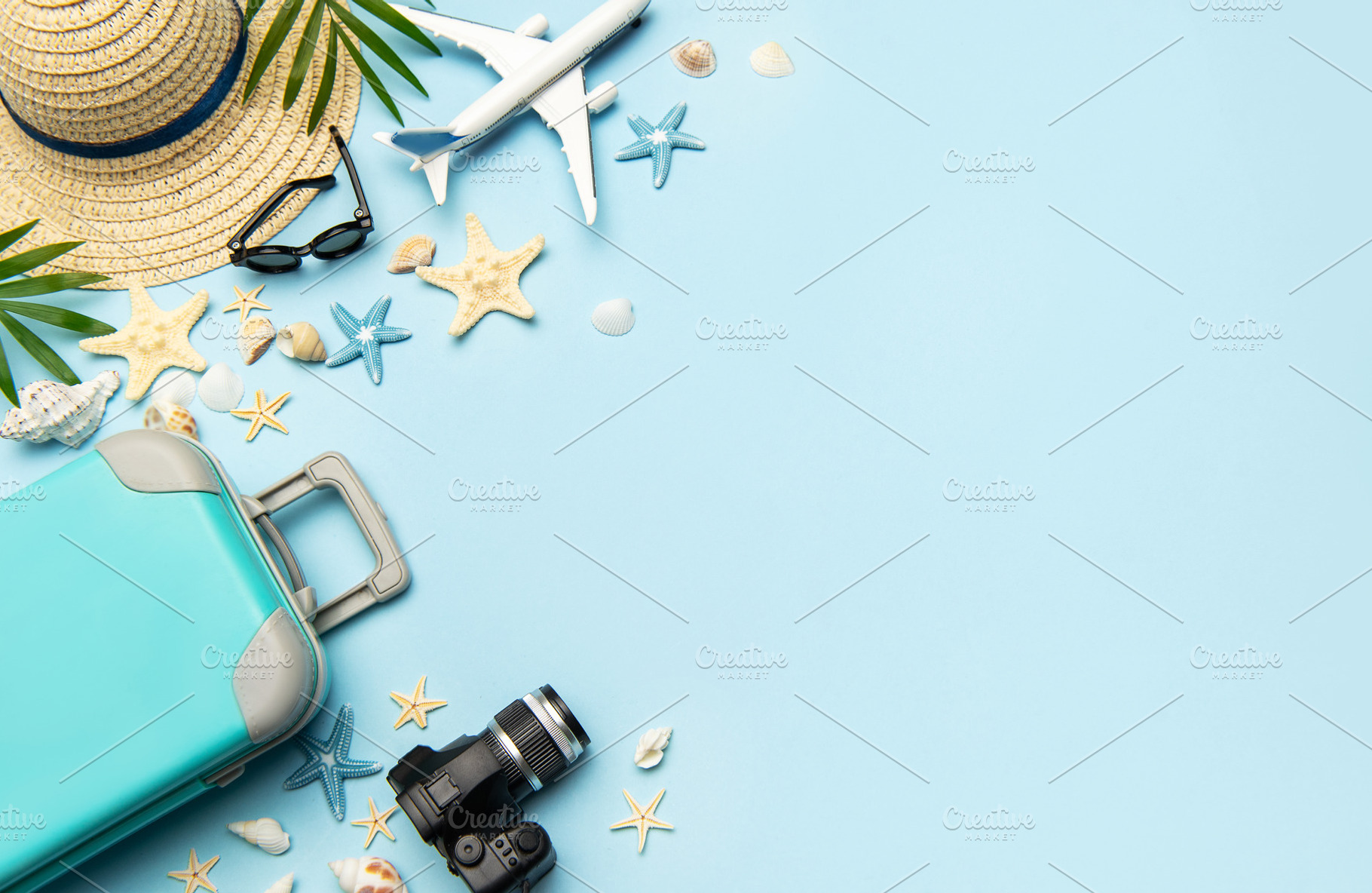 Travel accessories creating a frame on light blue background wit, a Holiday Photo by Olena Rudo