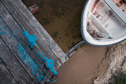 Old boat on an old wooden blue wharf on a river-lake. Top view,, a Transportation Photo by TanaCh
