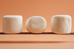 Marshmallows on a stick in a row, a Photo by Beautiful things