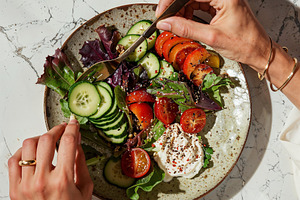 Photo of woman eating salad, a Food & Drink Photo by AS Studio