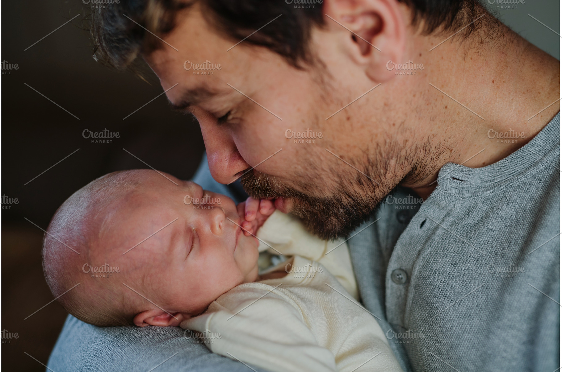 Close-up of father cudddling his, a Person Photo by HalfPoint