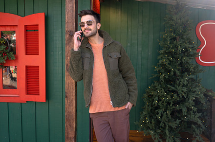 Handsome man have phone call, extends holiday greetings using his mobile phone, a Person Photo by andreonegin market