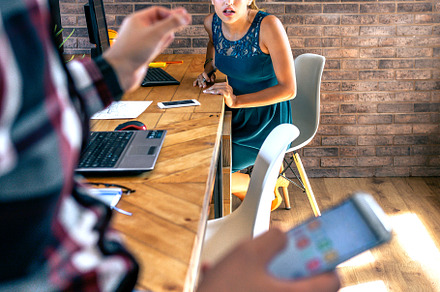 Woman surprised by what her coworker, a Business Photo by davidpereiras