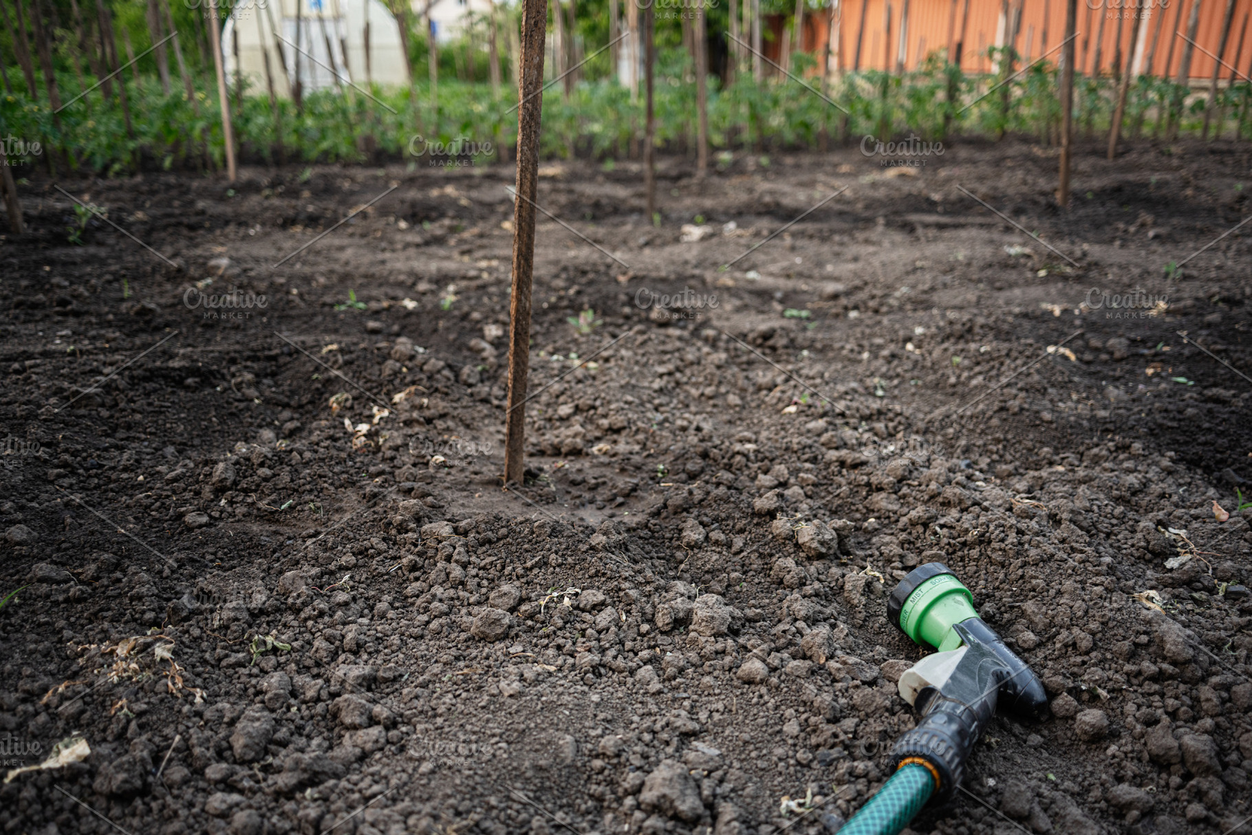 Gardening equipment and prepared soil plot for agricultural tasks in a rural ar, a Photo by AS photostudio