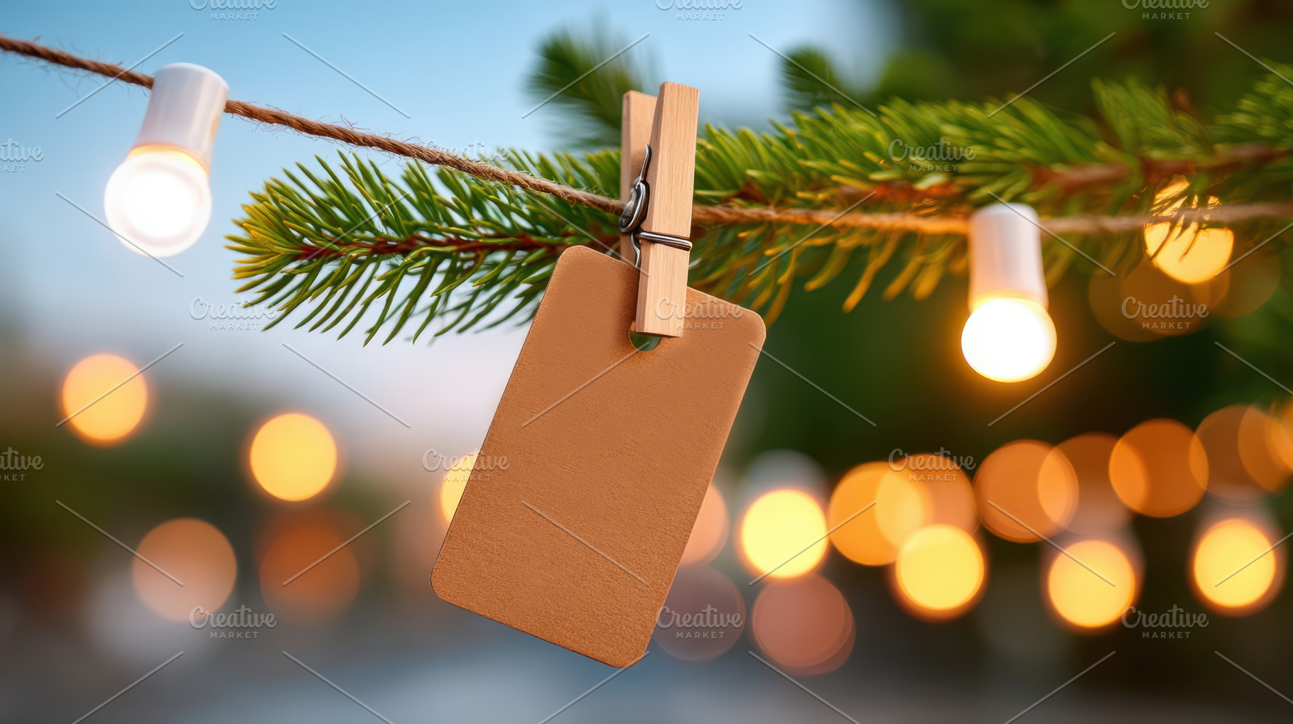 Blank tag on pine branch with string lights, a Holiday Photo by AlyaAnd