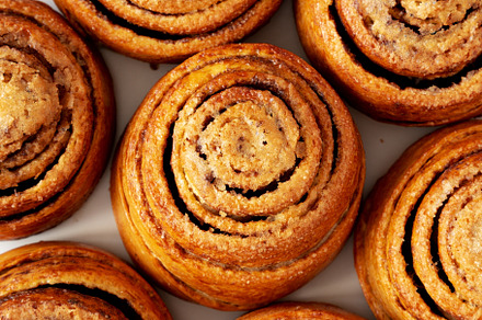 Homemade Cinnamon Roll Pastry on a white wooden background, top, a Food & Drink Photo by LiudmylaChuhunova