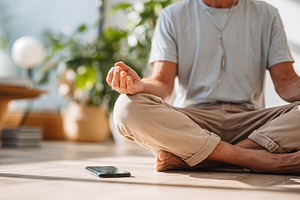Meditation practice in a bright indoor space with smartphone nearby, a Photo by AlyaAnd