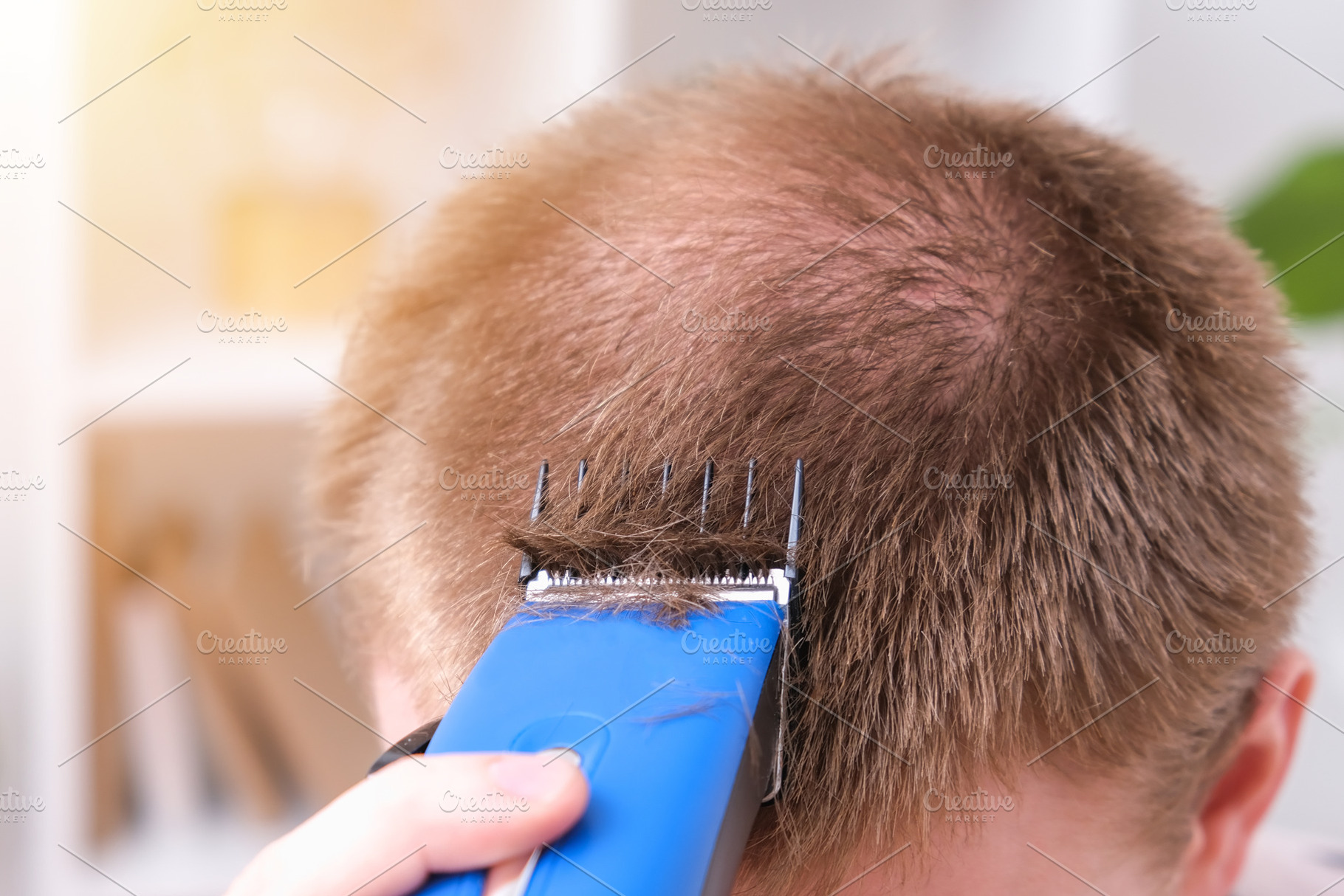 A man cuts his hair with clipper. Cutting a short hairstyle at home. Close-up., a Technology Photo by Detriana