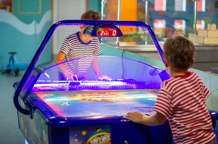 Boys play air hockey, entertainment