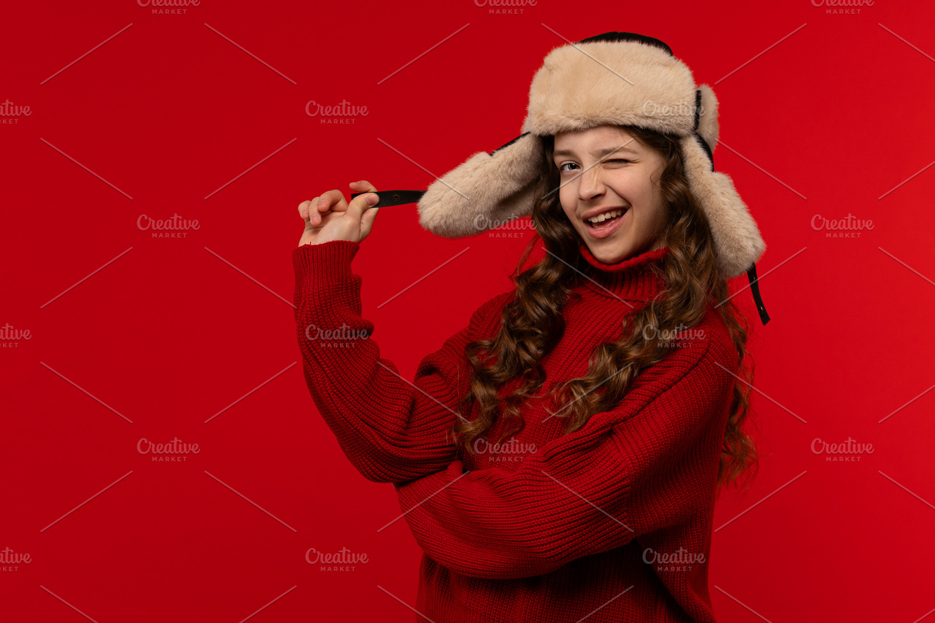 Playful girl in red sweater and fur, a Holiday Photo by Elena Vagengeim