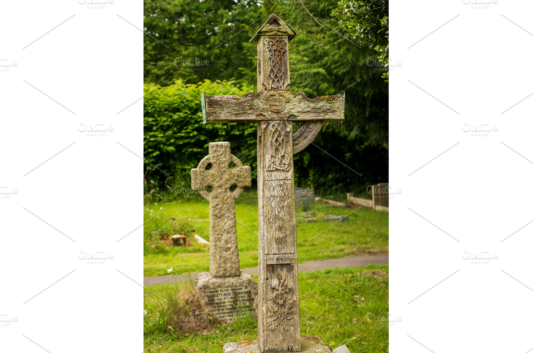 Old oak framed cross in graveyard in, a Nature Photo by Backyard Stock