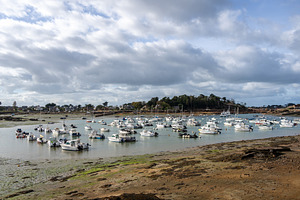 Ploumanach harbor filled with boats under cloudy sky in Brittany, a Transportation Photo by GoodGoods