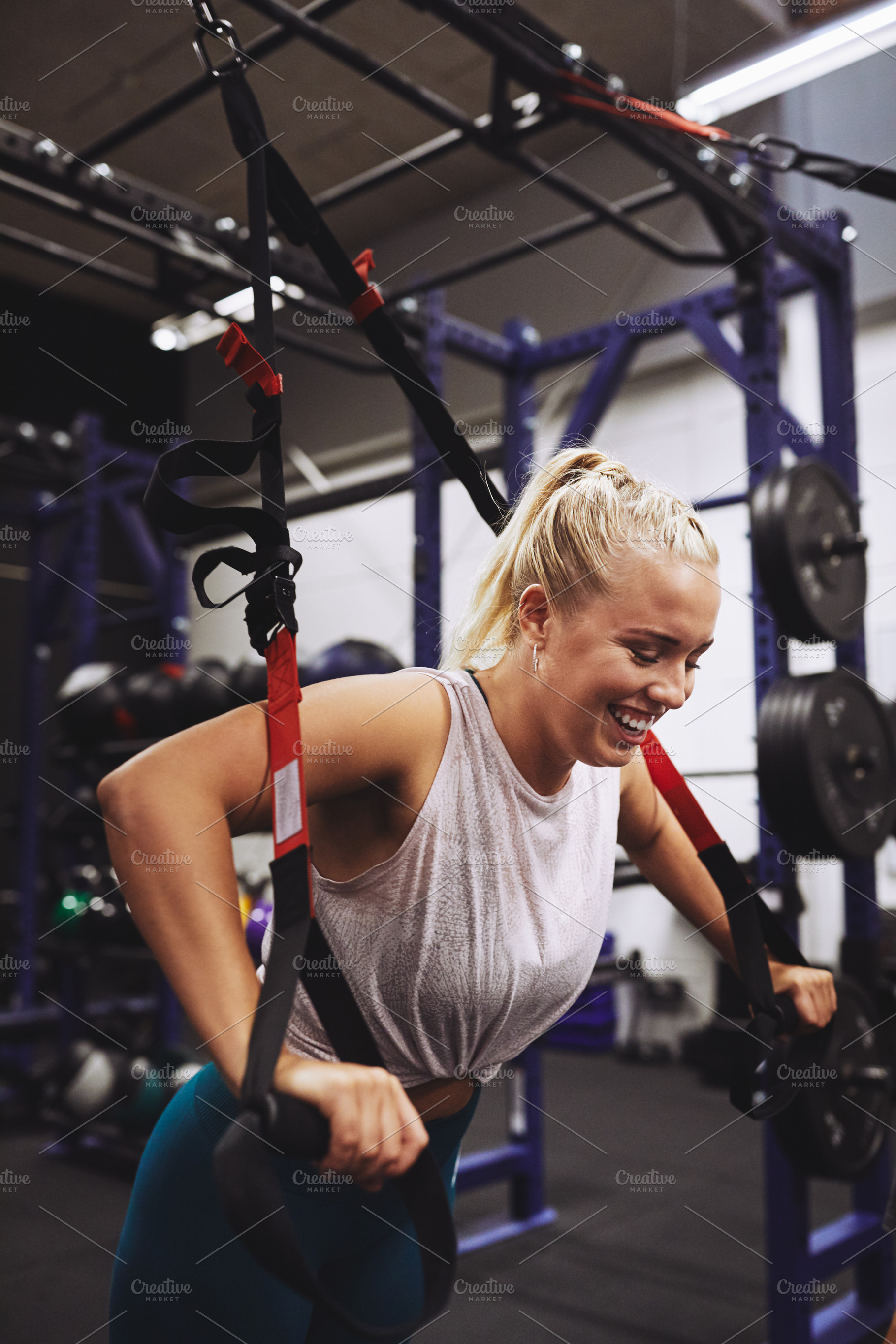 Young woman laughing while working out at the gym, a Sports & Recreation Photo by Stefan & Janni