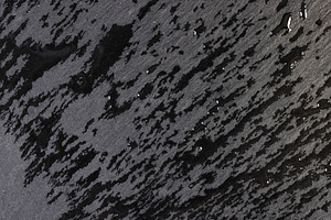 black wet slate that is used for the background, a Photo by rsoollAI