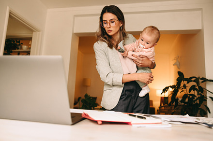 Professional interior designer holding her baby in her home offi, a Person Photo by Jacob Lund