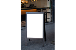 Blank wooden frame sign on sidewalk, a Business Photo by volodymyrshtun13795