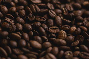 Roasted coffee beans forming a detailed surface, representing en, a Photo by Studio ANNA