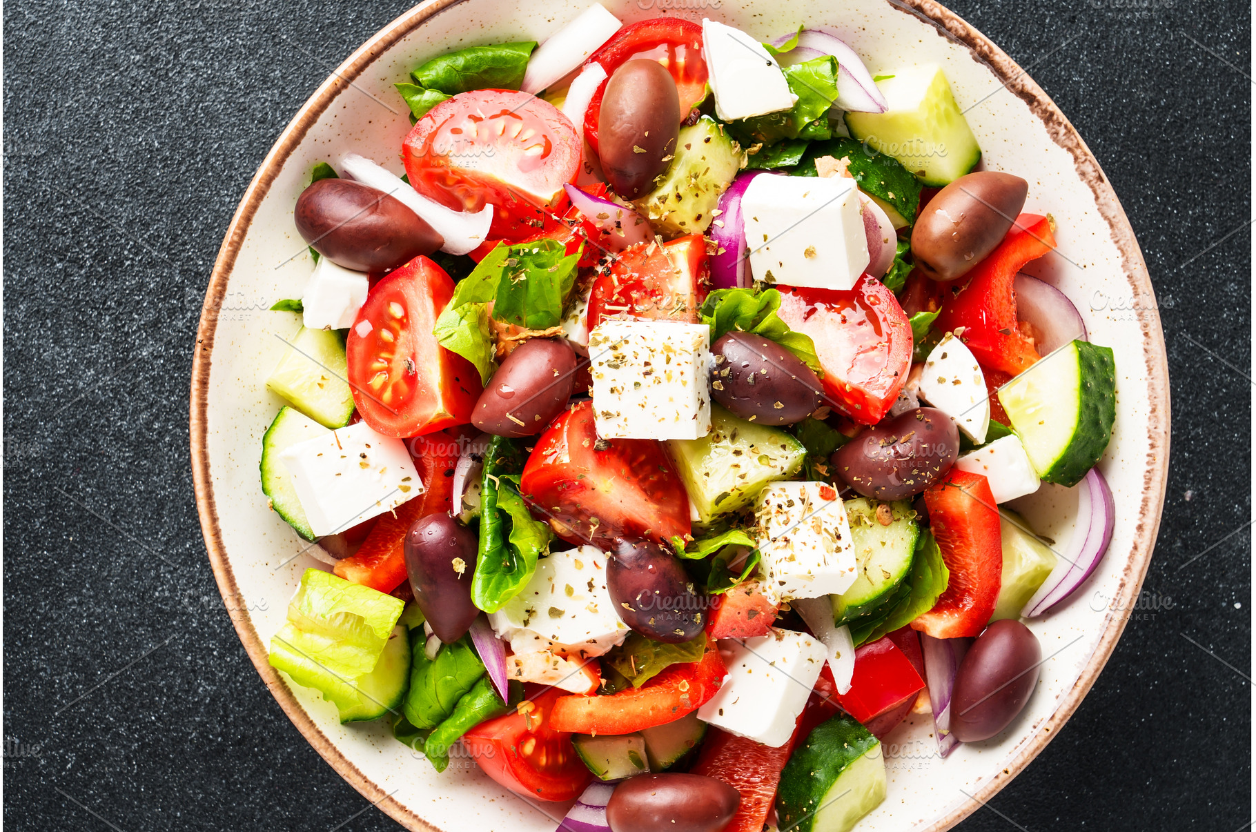 Greek salad in craft plate on black, a Food & Drink Photo by Nadia-nb