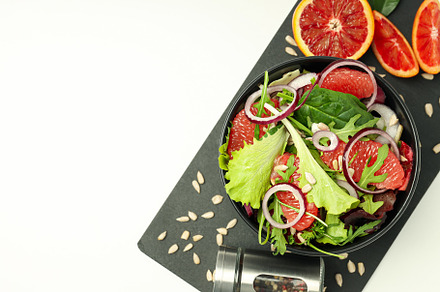 Concept of tasty food, salad with red orange, space for text, a Food & Drink Photo by AtlasStudio
