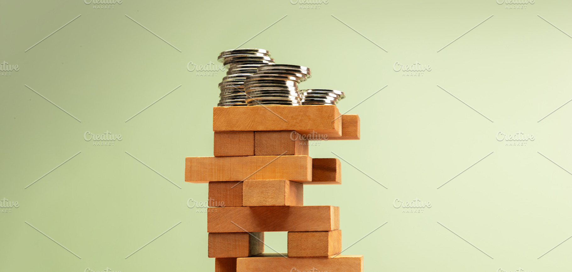 Stacked coins atop unstable Jenga tower, symbolizing high risk i, a Photo by salmon.black