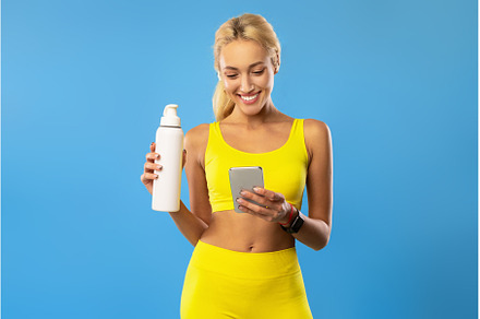 Sporty woman holding bottle with, a Person Photo by Prostock-Studio