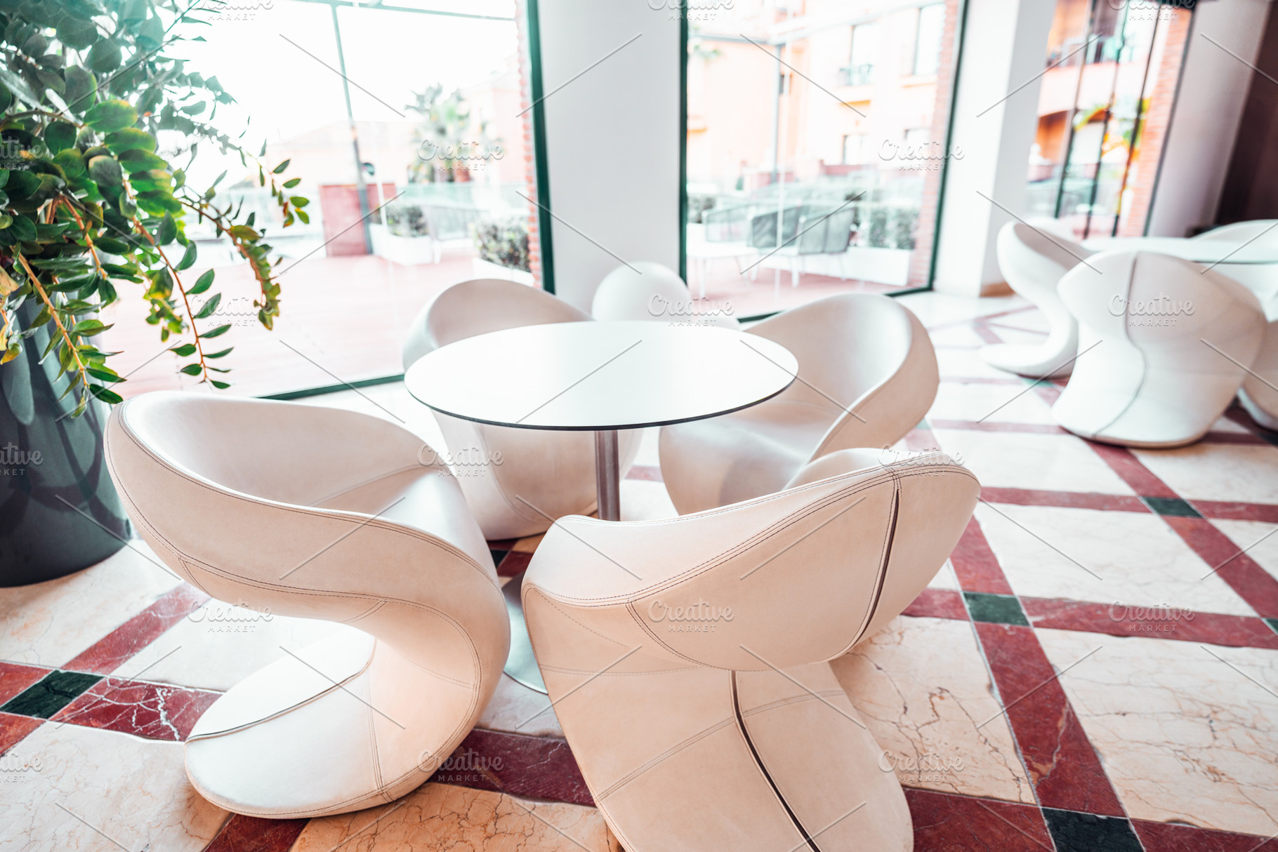 Modern cafe seating with glass view, an Architecture Photo by SkyNext