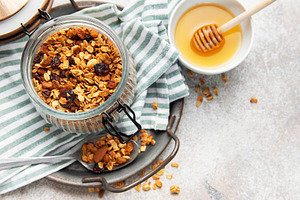 Healthy homemade granola breakfast cereal in glass jar, a Food & Drink Photo by Olena Rudo