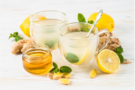 Ginger tea with lemon at white table, a Food & Drink Photo by Nadia-nb