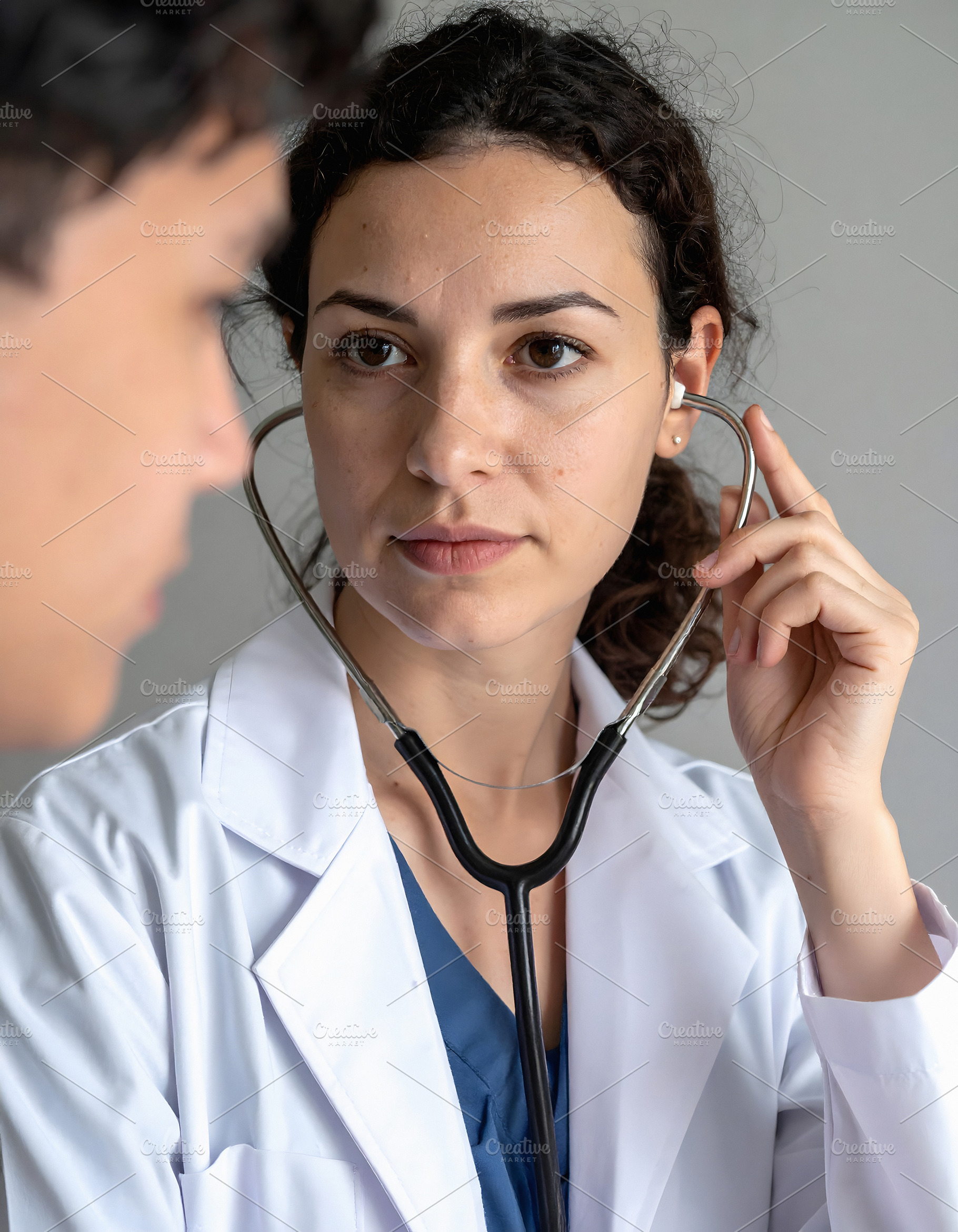 Doctor consulting patient in professional medical portrait, a Health & Medical Photo by GoodGoods