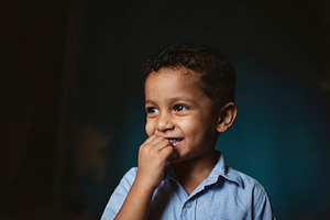 Portrait of Young Boy with Shy Smile, a Person Photo by Virgo Studio