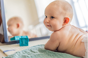 Baby lying on play mat learning to, a School & Education Photo by Elizaveta Galitskaya