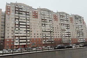 A row of modern apartment buildings in a snowy urban setting, with parked cars, an Industrial Photo by Textures & Backgrounds