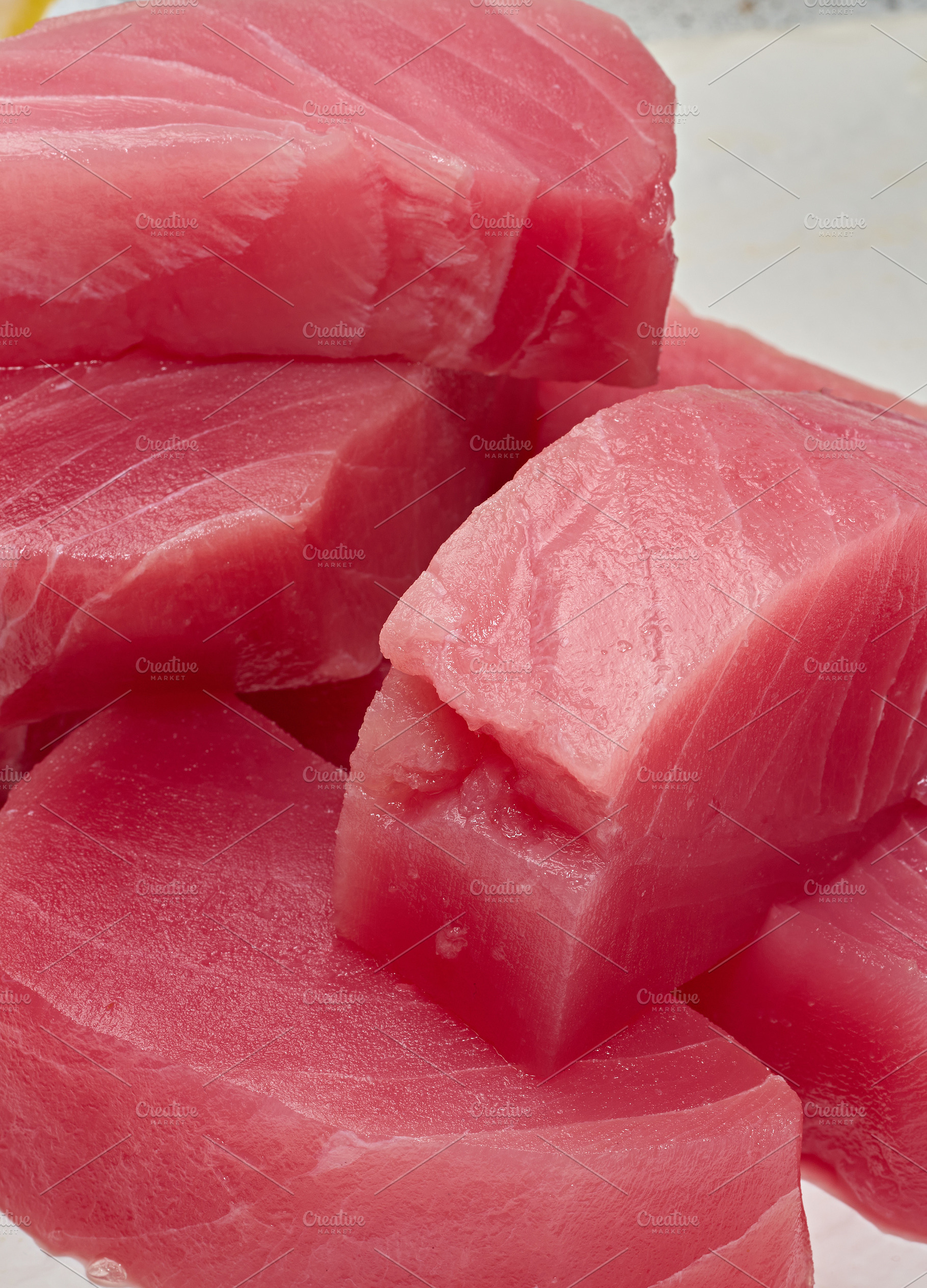 A stack of raw tuna pieces on a white board, a Food & Drink Photo by ndanko