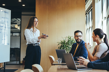 Businesswoman discussing her marketing strategy with her team, a Person Photo by Jacob Lund