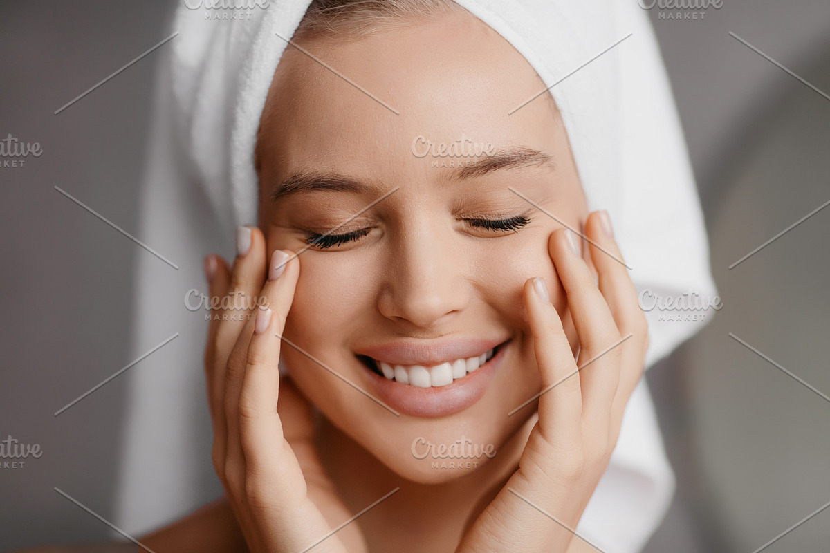 Pretty woman using antiperspirant for underarms, standing near mirror in bathro, a Photo by Prostock-Studio (Photo 3 of 3)