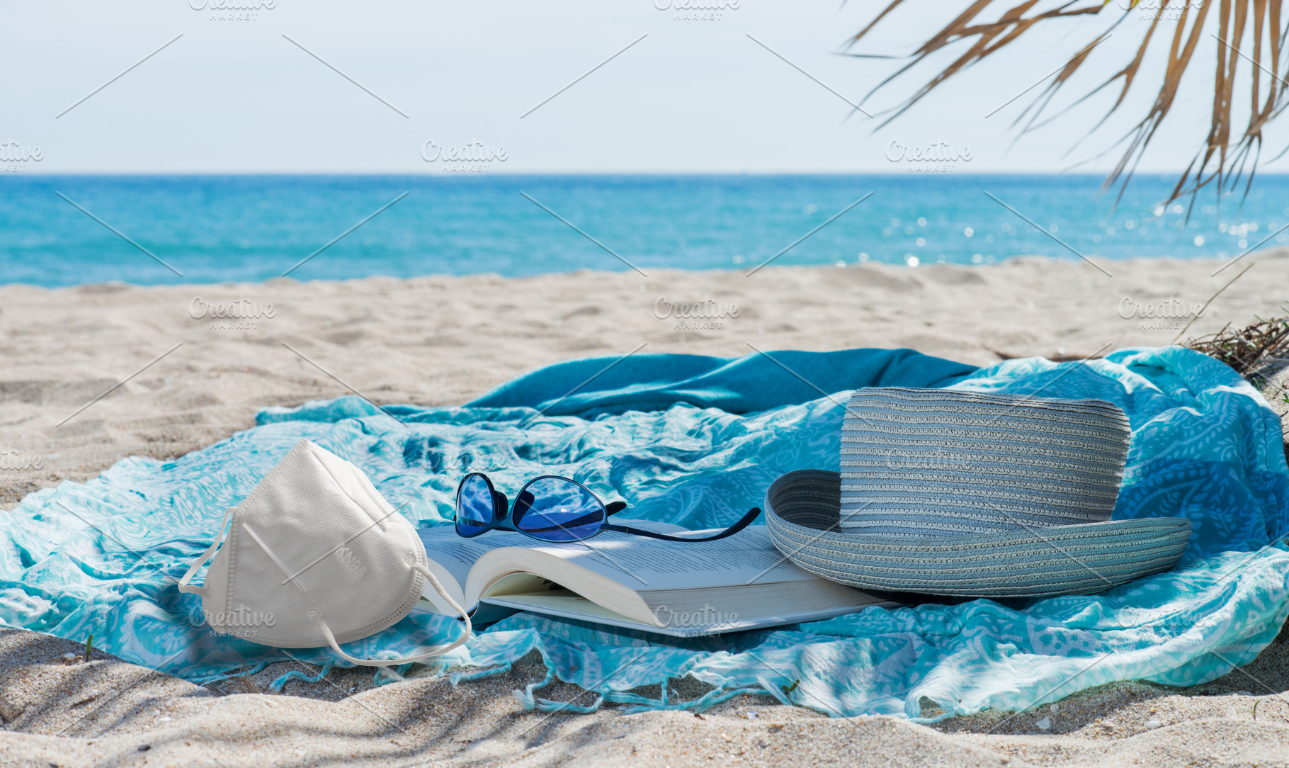 Sanitary face mask, hat, book, towel, a Holiday Photo by Claudio Valdés