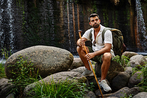 Hiker contemplating a waterfall whil, a Person Photo by Perpis