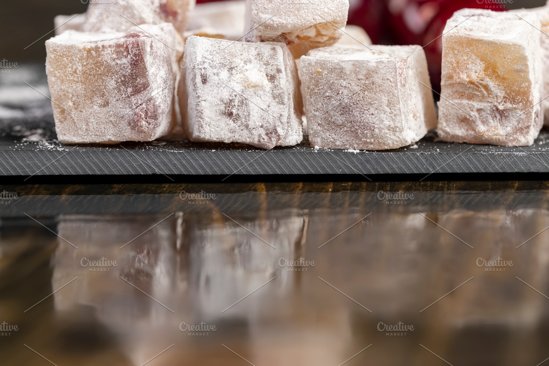 cubes of sweet Turkish delight with the addition of dried red berries in powder, a Photo by rsoollAI
