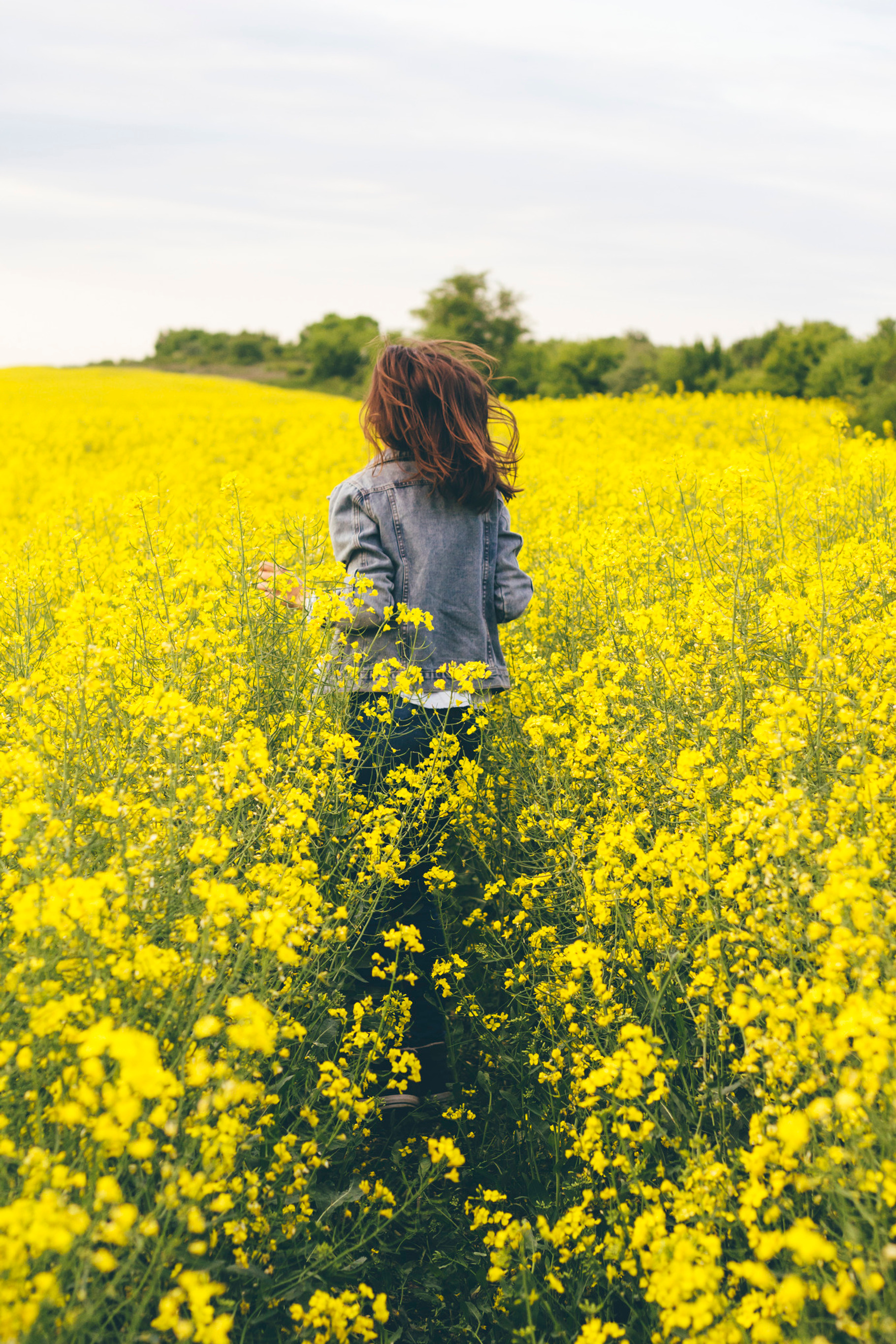 Girl running in a yellow field containing girl, run, and running, a Person Photo by Mukuko Studio