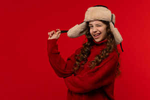 Playful girl in red sweater and fur, a Holiday Photo by Elena Vagengeim