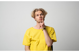 Thoughtful young man in yellow t, a Person Photo by volodymyrshtun13795
