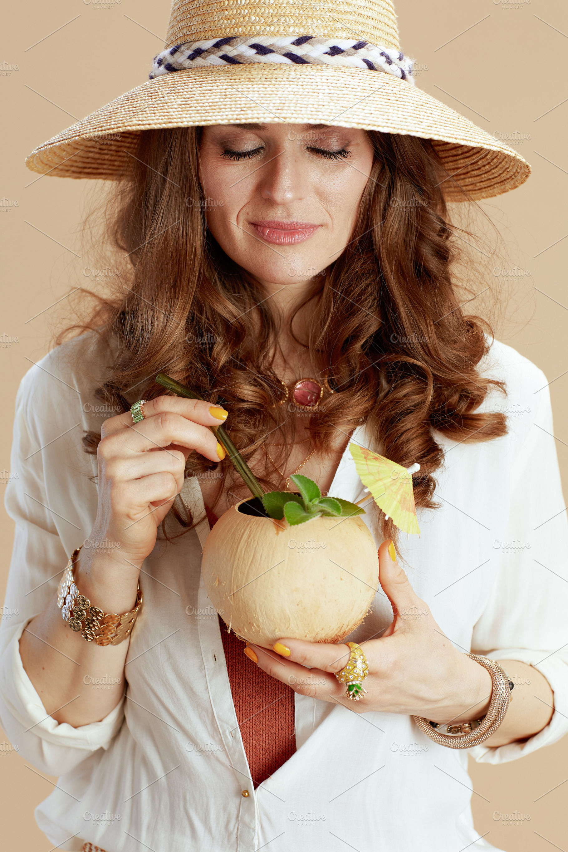 happy woman in blouse and shorts on beige, a Person Photo by Alliance Images