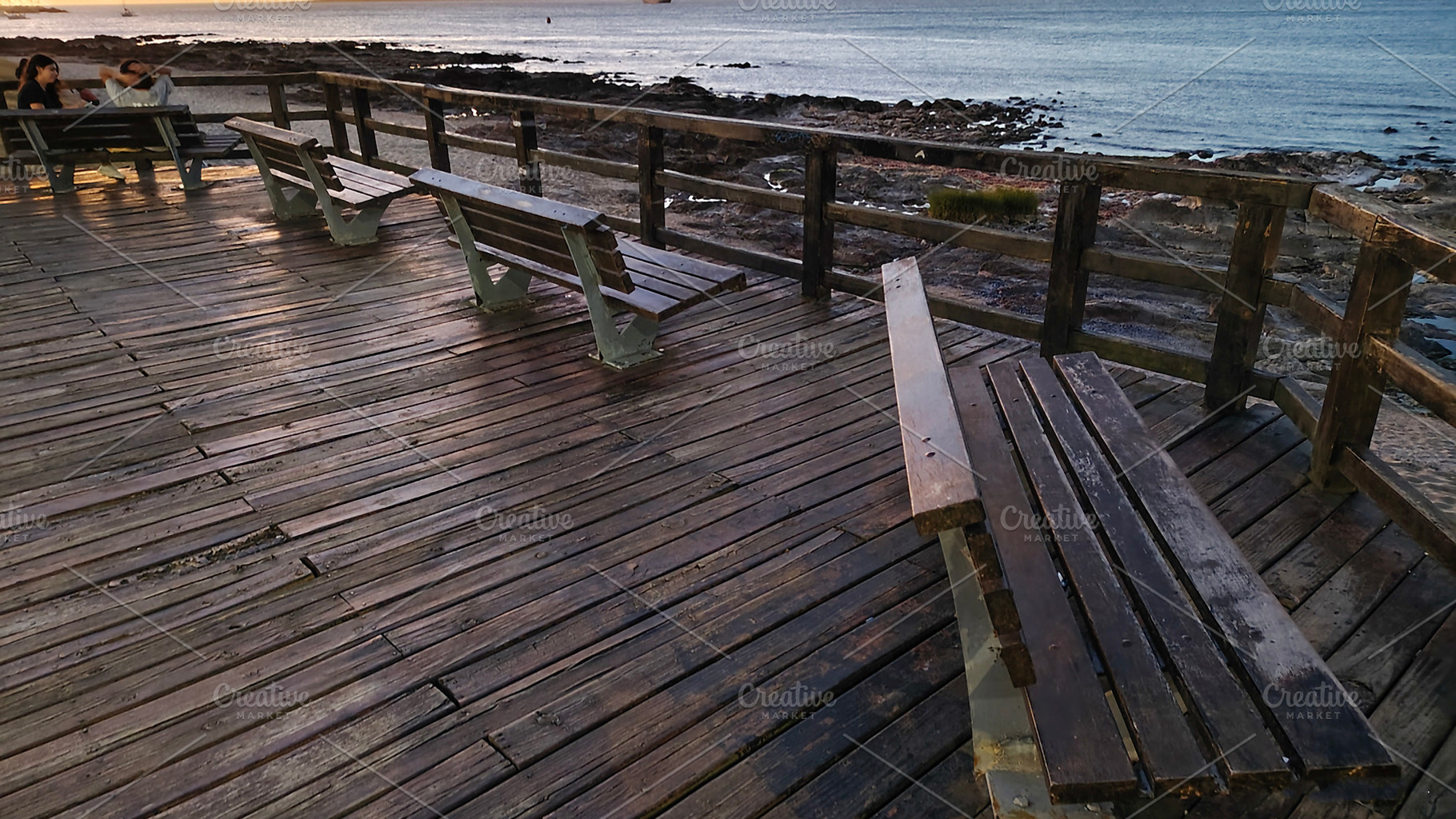 Promenade stop with wooden seats at coast of atlantic ocean, pun, a Holiday Photo by DanFLCreativo