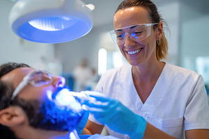 Dentist performing procedure in modern clinic, a Health & Medical Photo by AlyaAnd