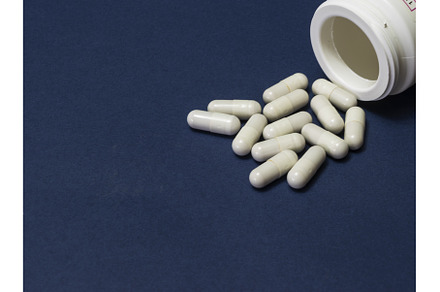 Pills spilled out of white bottle on, a Health & Medical Photo by shahin.mammadov