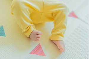 Adorable baby in a yellow hat lying, a Person Photo by Elizaveta Galitskaya