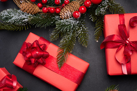 Christmas wreaths, fir branches and gifts on a black background., a Holiday Photo by ndanko