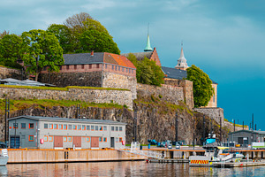 Akershus Fortress reflected in Oslo harbor, Norway, a Photo by Nito