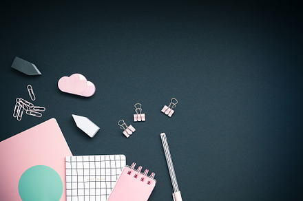 Pink colored objects on black background, top view, a School & Education Photo by Dvoevnore photos